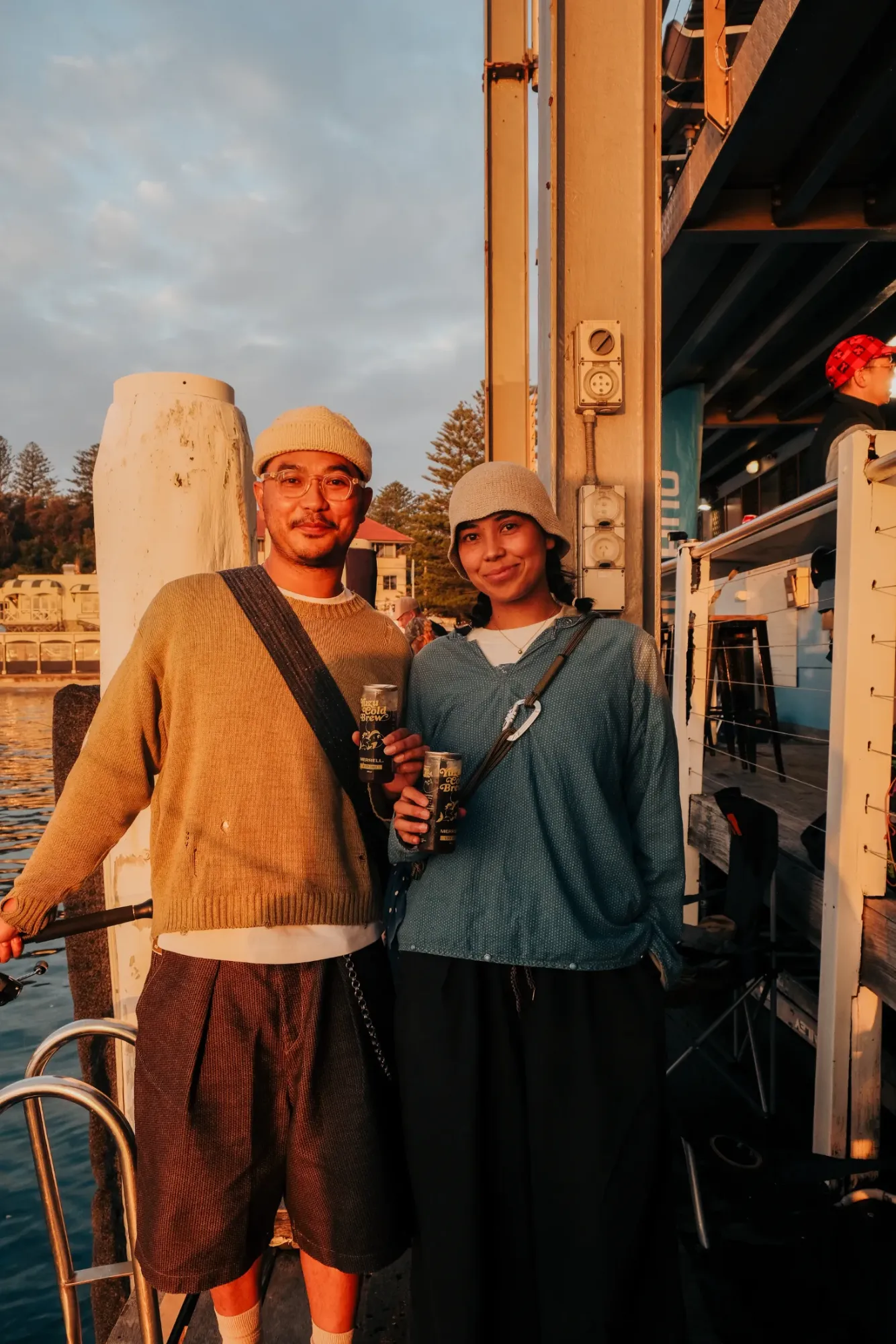 Guests holding Yuzu Cold Brew cans on the wharf
