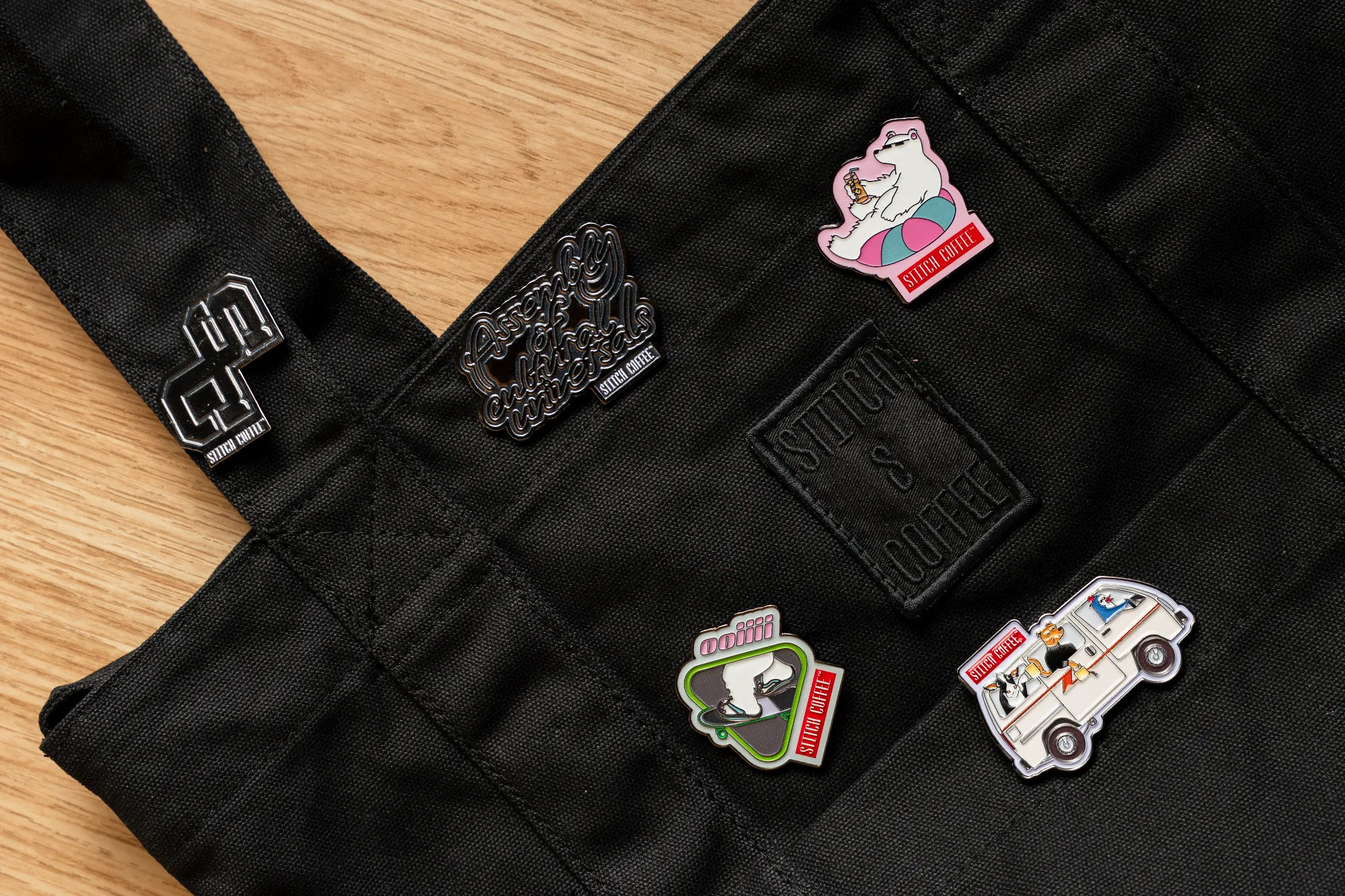 Enamel pins on a canvas apron